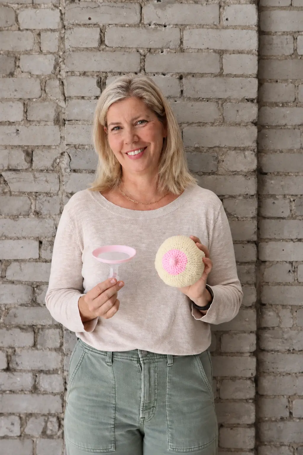 A lactation consultant holding breastfeeding teaching tools