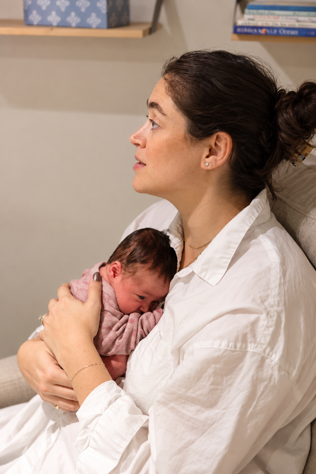 A parent holding her newborn during a lactation consultation